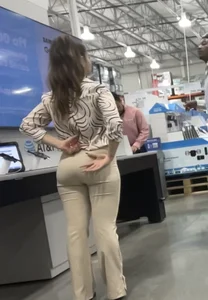 Plus Face shot - Gorgeous AT&T babe in beige pants  touching her ass with long red nails