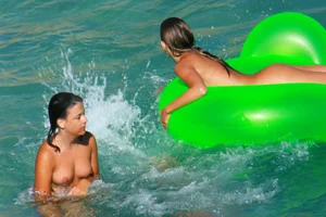 FKK Nudists playing in the water with floater