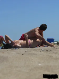 Purple thong topless lady on the beach gets oiled up by her husband