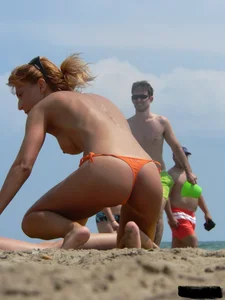 Two topless friends on the beach with nice boobs