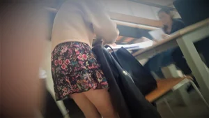 Skinny girl in a skirt bending over