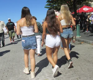 Three sexy friends in denim shorts and a skirt