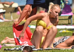 Blonde looking sexy in a yellow bikin