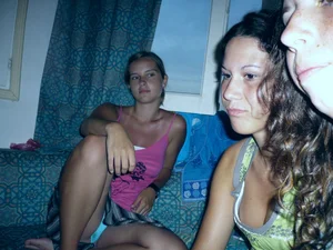 Young candid hottie accidentally flashing her panties under skirt while sitting on the couch at home photo