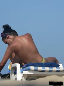 Hot ass topless beach girl with great tits lets her little brother oil up her ass in thong bikini