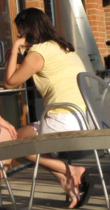 Lady in flop flops while eating showing her feet