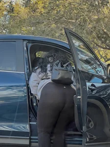 Girl in yoga pants bending over to the car street creepshot