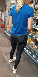 German Girl with shiny leather Jeans Ass in supermarket