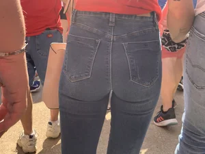 Bunch of girls in various outfits at a Cardinals baseball game