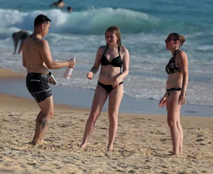 Cute bikini girl in the water in a black bikini