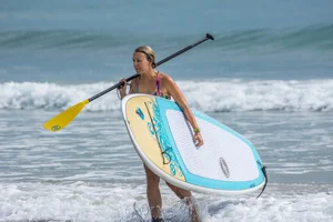 Candid girls surfing on the beach
