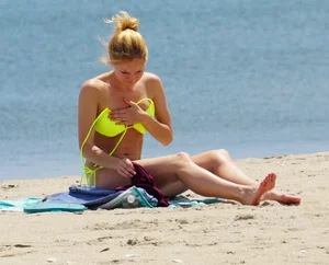 Sexy ass blonde milf on the beach in a thong with cameltoe and bending over