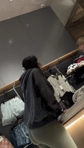 Sexy bubble butt in tight green leggings at the mall