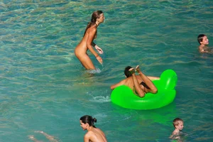 FKK Nudists playing in the water with floater
