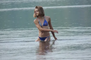 Skinny teen having fun in her little England bikini