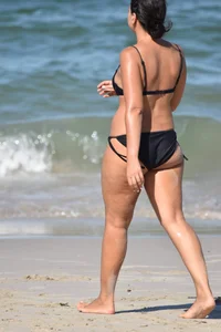 Thick mature brunette bikini lady on the beach with a nice body