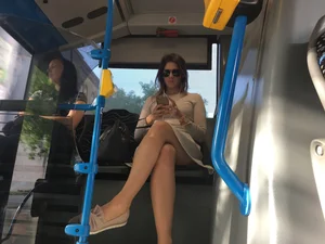 Hot candid chick wearing a skirt sitting in a public bus with crossed legs