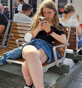 Candid Teen Girl With Awesome Legs in Shorts Sitting With Crossed Legs at the Railway Station Creepshots