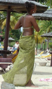 Sexy black babe in various bikinis on the beach while on vacation