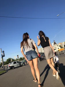 Two Hot Girls on a Street in Denim Shorts and a Skirt - One Touching Her Booty - Creepshots Gallery