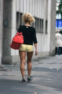 Blonde looking sexy walking in short yellow shorts