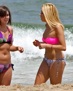 One blonde and one brunette bikini babes at the beach