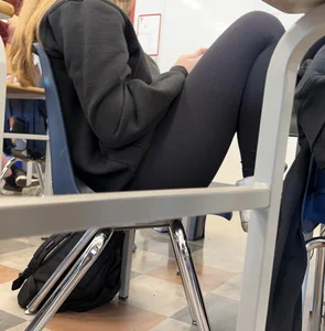 College teen in leggings sitting at her desk in class creepshots