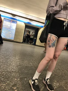 A Tall And Slim Candid Girl in Spandex Shorts in a Hoodie Top, With Tattoos on Her Long Legs Subway Creepshots