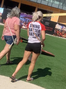 Bunch of girls in various outfits at a Cardinals baseball game