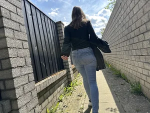 Sexy girl in tight blue jeans walking down a suburban street creepshots