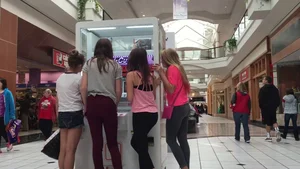 Little blonde teen in grey leggings at the mall with her friends