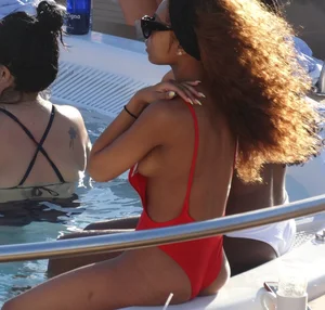 Sexy black girl in red swimsuit at the pool with side boob and a nice ass