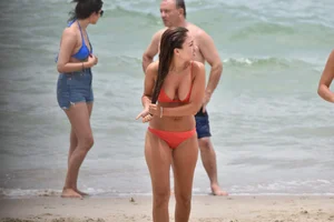Two sexy ass girls on the beach in bikinis