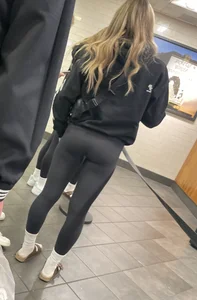 Tight ass sports team in line at airport
