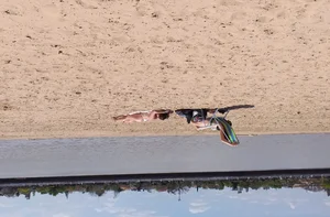 Girl laying out getting sun in a white thong bikini