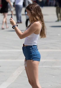 Sexy girl showing her cheeks in tight and tiny denim shorts