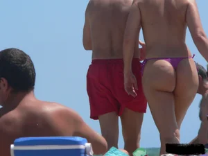 Purple thong topless lady on the beach gets oiled up by her husband