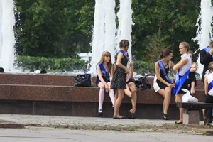 Young College Girls in Dresses, Skirts And Pantyhose Having a Good Time By the City Fountain