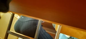 Booty of a College Student Sitting behind the Desk in Classroom Creepshot