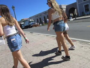 Three sexy friends in denim shorts and a skirt