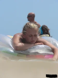 Sexy blonde on the beach in a yellow thong bikini