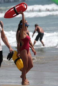 Two sexy lifeguards in red and blue swimsuits