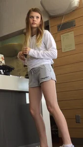 Gorgeous teen in shorts in a cafe