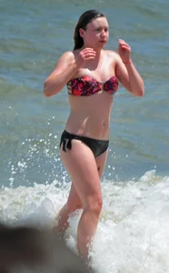 Cute beach girl in little bikini in the water