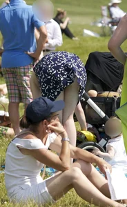 Pale milf in a skirt giving a peek at her green panties