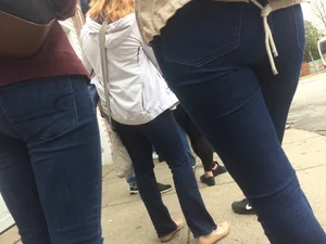 2 nice asses in tight jeans standing around