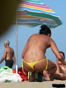 Bunch of sexy babes on the beach topless and in thong bikinis