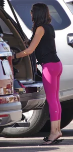 Milf brunette in purplish-pink leggings looking sexy in the parking lot