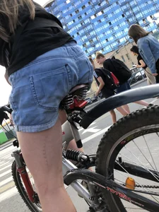 Girl in denim shorts on a bike street pics