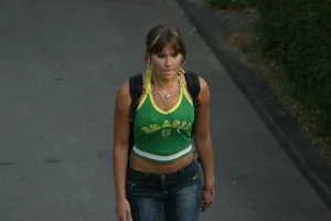 Pretty girl playing tennis in a skirt and walking in jeans